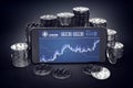 Smartphone with Litecoin trading chart on-screen among piles of silver Litecoins.