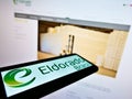 Smartphone with logo of Brazilian pulp manufacturer Eldorado Brasil Celulose SA on screen in front of website.