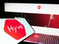 Smartphone with logo of British event management company Hyve Group plc on screen in front of website.