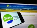 Smartphone with logo of company Sociedad QuÃÂ­mica y Minera de Chile (SQM) on screen in front of website.