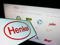 Smartphone with logo of consumer goods company Henkel AG Co. KGaA on screen in front of business website. Royalty Free Stock Photo
