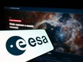 Smartphone with logo of Europen organization European Space Agency (ESA) on screen in front of website.