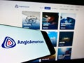 Smartphone with logo of global metals and mining company Anglo American plc on screen in front of web page.