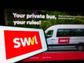 Smartphone with logo of mass transit company SWVL Technologies Inc. on screen in front of business website.