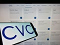 Smartphone with logo of private equity company CVC Capital Partners on screen in front of business website.