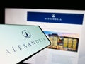 Smartphone with logo of US company Alexandria Real Estate Equities Inc. on screen in front of website.