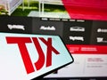 Smartphone with logo of US department store company The TJX Companies Inc. on screen in front of web page.