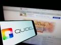 Smartphone with logo of US diagnostics company Quidel Corporation on screen in front of business website.