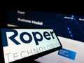 Smartphone with logo of US engineering company Roper Technologies Inc. on screen in front of website. Royalty Free Stock Photo