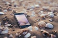 Smartphone lost mobile phone cellphone modern gadget lying sand beach tropical sunny white sandy seashore seashells