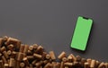 Smartphone and a lot of wine corks. Top view. 3D rendering Royalty Free Stock Photo