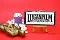 Smartphone with LucasFilm studio logo, Oscar figure and popcorn. Film industry concept.