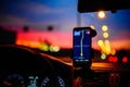 Smartphone with map on the screen in car. Automobile dashboard in night mode Royalty Free Stock Photo