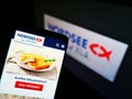 Smartphone with meal of German fast-food restaurant chain Nordsee GmbH (seafood) on display in front of company logo.