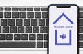 Smartphone with Microsoft Teams App Logo inside House Working Remote From Home Quarantine or Lockdown Concept