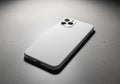 A smartphone with a minimalist white case lies on a speckled Royalty Free Stock Photo