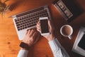 Smartphone mock up overhead shot, businessman holding mobile phone with blank screen over office desk Royalty Free Stock Photo