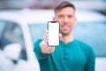 Smartphone mockup, blank screen. Young smiling man shows phone with blank space Royalty Free Stock Photo