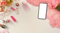 A smartphone mockup, female pink accessories and copy space on white background