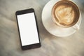 Smartphone mockup with latte frothy foam, coffee cup top view Royalty Free Stock Photo