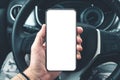 Smartphone mockup in male driver hand over car steering wheel Royalty Free Stock Photo