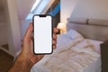 Smartphone mockup screen, man using mobile phone in bedroom Royalty Free Stock Photo