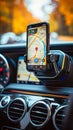 Smartphone mounted on a car dashboard displaying a navigation map application, indicating a destination point for a driver in a Royalty Free Stock Photo