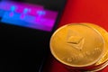 Smartphone with NFT application on abstract red background with ethereum coin, top view photo