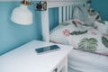 Smartphone on nightstand near bed in hotel room. Modern interior. Technology and people concept Royalty Free Stock Photo