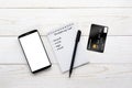 Smartphone, notebook, pen and credit card on a white table Royalty Free Stock Photo