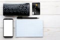 Smartphone, notebook, pen and credit card on a white table Royalty Free Stock Photo