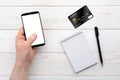 Smartphone, notebook, pen and credit card on a white table Royalty Free Stock Photo