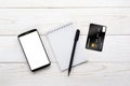Smartphone, notebook, pen and credit card on a white table Royalty Free Stock Photo