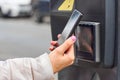 Smartphone payment with NFC technology for public parking with copy space. Contactless payment concept.