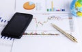 Smartphone and pen on stock infomation chart for finance concept Royalty Free Stock Photo