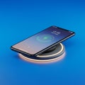 Smartphone placed on a wireless charging pad, set against a blue background. The Royalty Free Stock Photo
