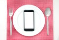 Smartphone on plate Royalty Free Stock Photo