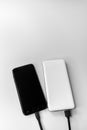 Smartphone and power bank during wired charging Royalty Free Stock Photo
