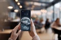 Smartphone with projected brain graphic, held by person. Royalty Free Stock Photo