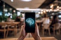 Smartphone with projected brain graphic, held by person. Royalty Free Stock Photo