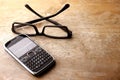 Smartphone with qwerty keypad and pair of eyeglasses