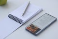 Smartphone with recipe and notebook with notes