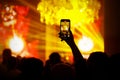 Smartphone recording concert in yellow light Royalty Free Stock Photo