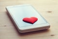 Smartphone with red heart on screen Royalty Free Stock Photo