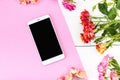 Smartphone, roses on the table. Women`s things Fashion womens desk Top view Mockup