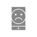 Smartphone with sad face gray icon. Negative review symbol.
