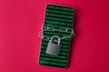 A smartphone with a screen displaying binary code, secured with a chain and a lock. Royalty Free Stock Photo
