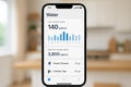 Smartphone screen displays water consumption data with graphs and figures, representing modern water usage tracking technology at Royalty Free Stock Photo