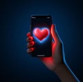 Smartphone screen with a red heart held in the palm of the hand. Heart as a symbol of affection and love Royalty Free Stock Photo