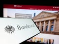 Smartphone with seal of German legislative body Bundesrat on screen in front of website.